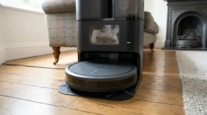 Self-emptying robot vacuum cleaner docked into its automatic dust collection station.