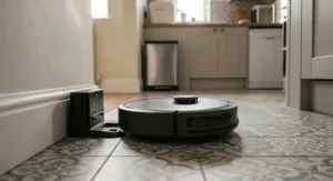 Affordable robot vacuum returning to its automatic charging station on a tiled kitchen floor