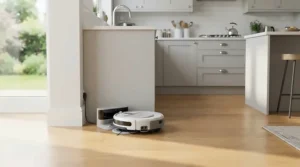 A self-washing mop robot vacuum returning to its automated base station in a modern kitchen